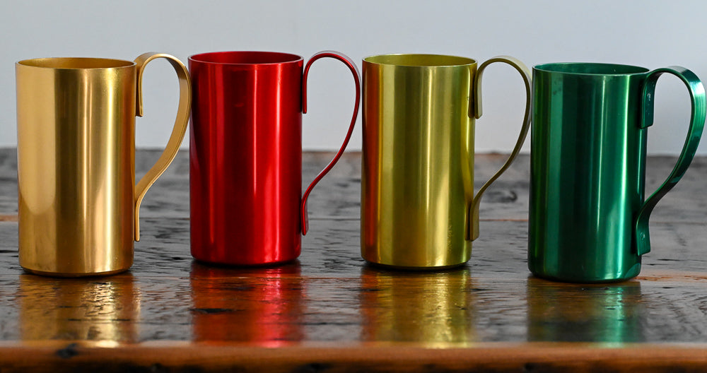metal mugs on wooden table