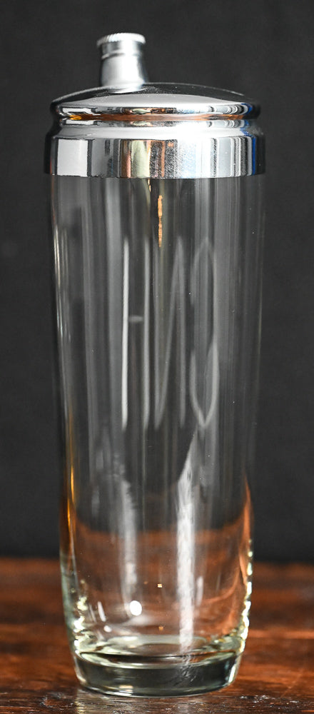 Clear glass cocktail shaker monogrammed with "CNH", metal lid