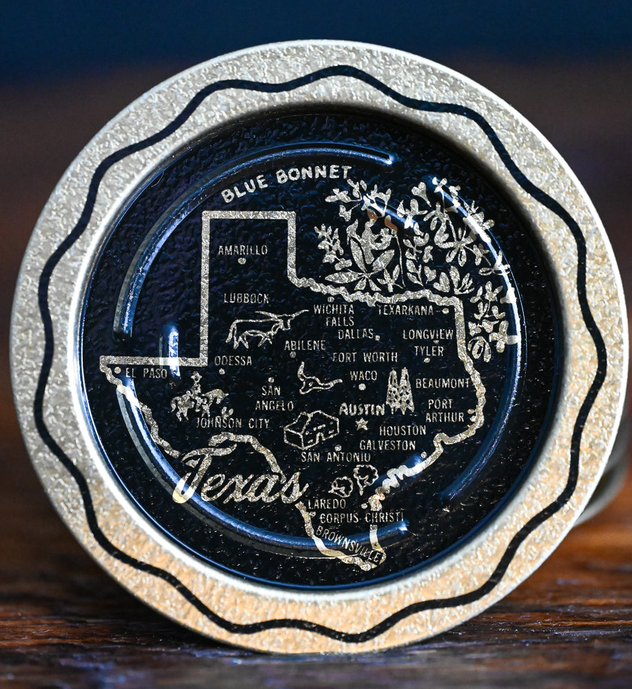 gold and black metal souvenir Texas coasters