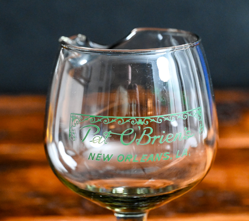 smokey grey mixing glass with green Pat O'Brien's written on it