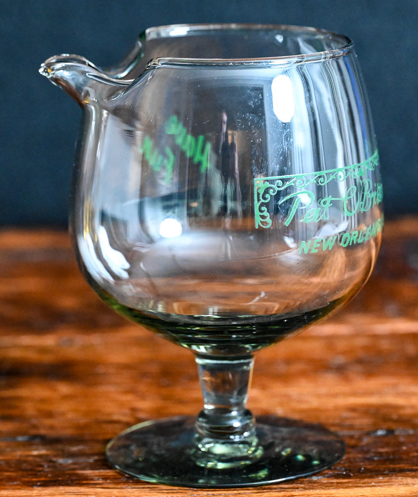 smokey grey mixing glass with green Pat O'Brien's written on it