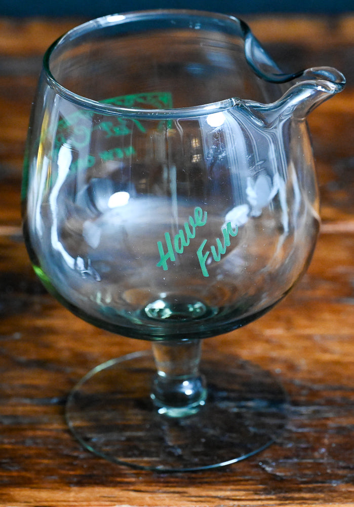 smokey grey mixing glass with green Pat O'Brien's written on it