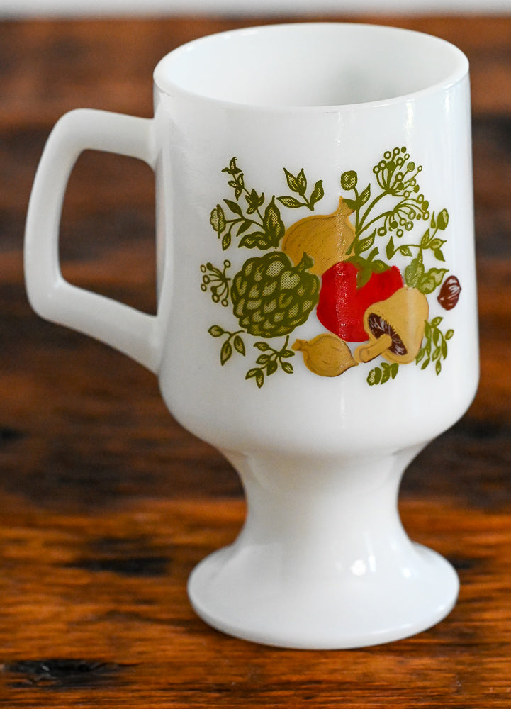 Corningware milk glass pedestal mug with handle, vegetable print