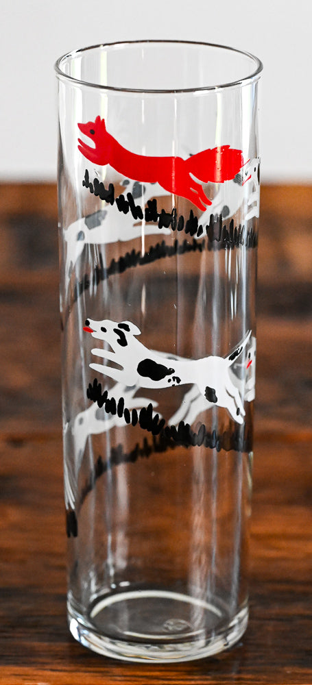 black and white dogs chasing a red fox collins glass