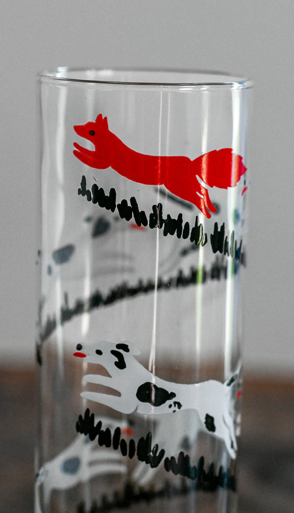 black and white dogs chasing a red fox collins glasses