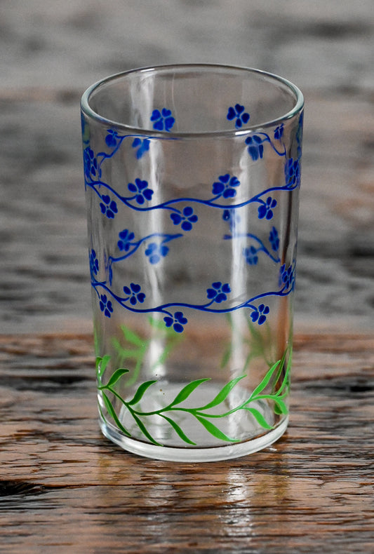 blue flowers and green vine on bottom juice glass