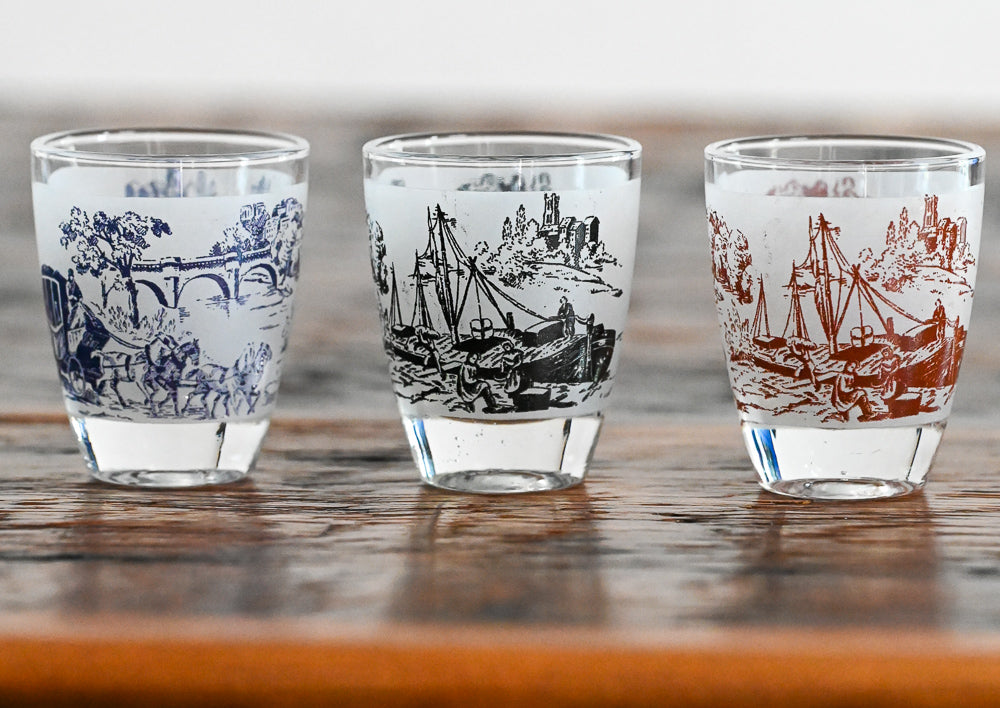 shot glasses with blue/green and red scenes