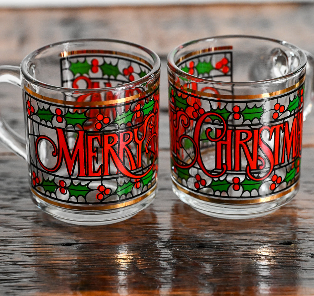 glass mugs with green and red foliage and print Merry Christmas