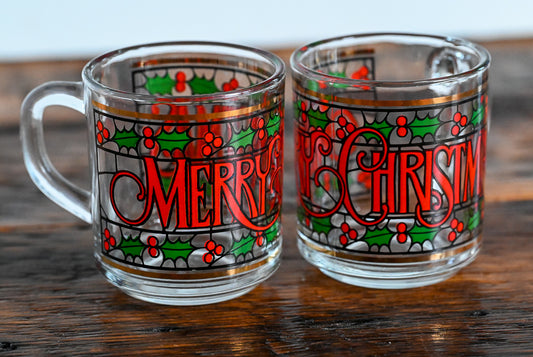 glass mugs with green and red foliage and print Merry Christmas