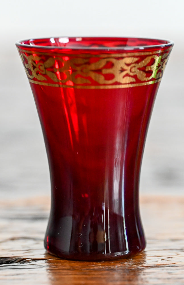red cordial glass with gold banding