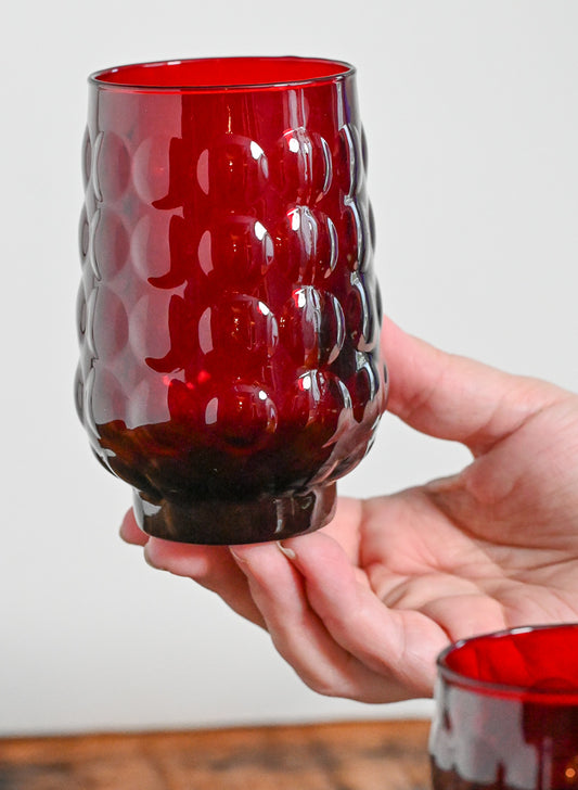 Anchor Hocking hand holding red bubble glass tumbler