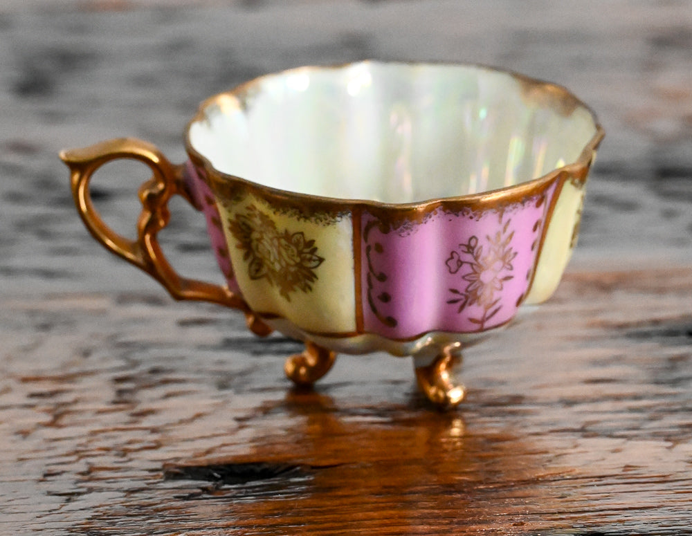 pink and cream teacup with gold handle, trim and legs