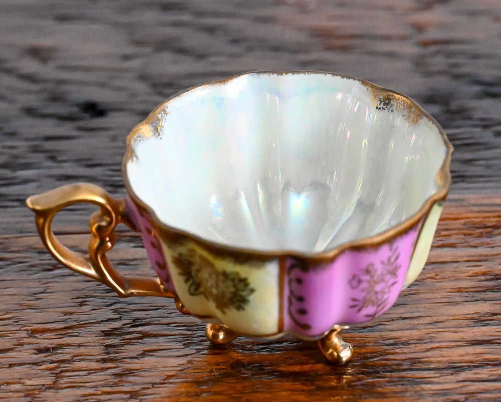 pink and cream teacup with gold handle, trim and legs