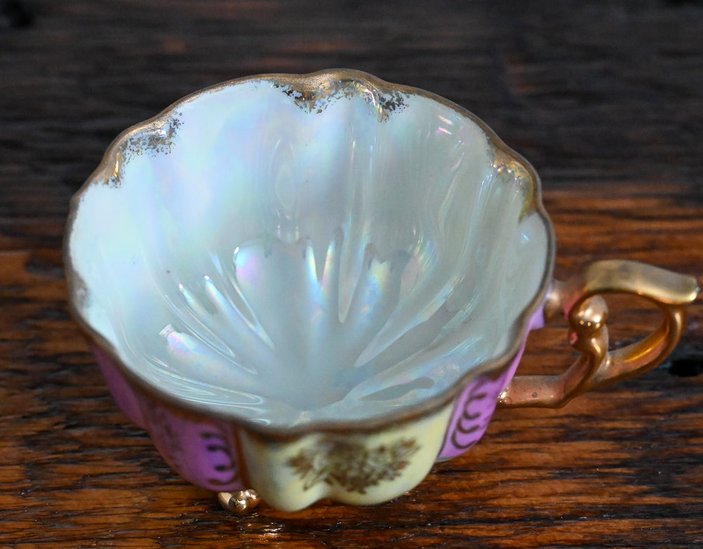 pink and cream teacup with gold handle, trim and legs