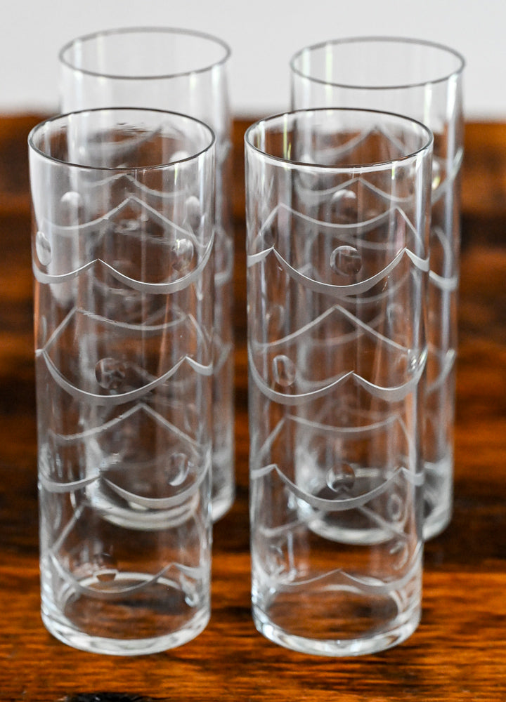 Etched highball glasses on wood table