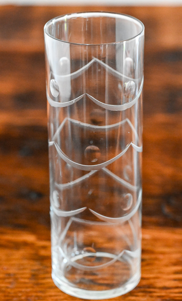 Etched highball glass on wood table