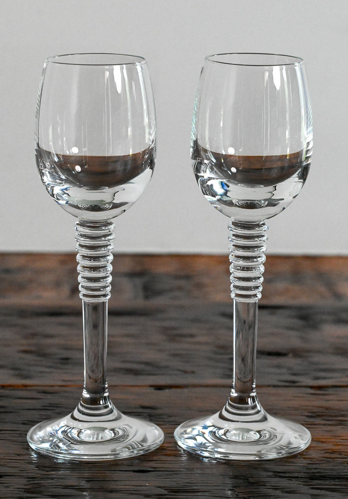 cordial glasses with stacked stem on wood table