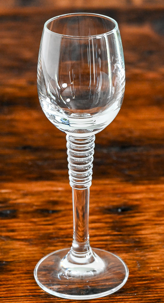 cordial glass with stacked stem on wood table