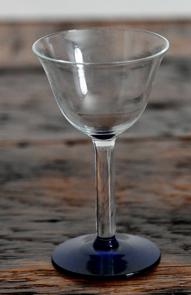 clear cocktail coupe with blue foot