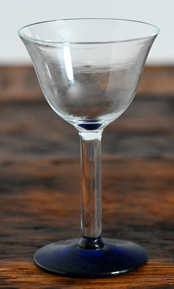 clear cocktail coupe with blue foot