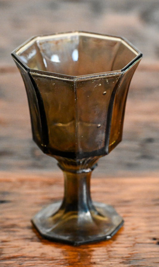 smoke brown goblet on wooden table