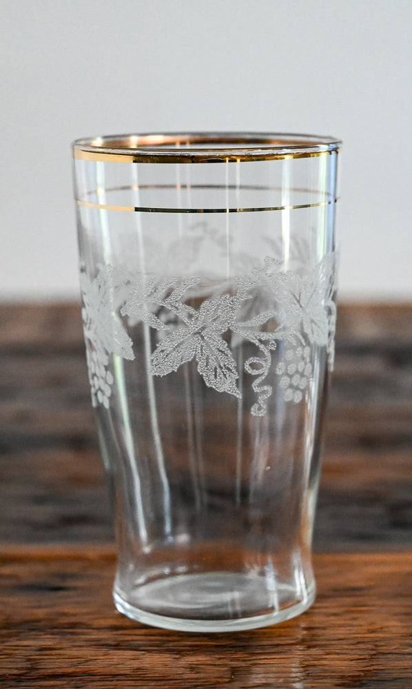 white etched gold rimmed glass on wood table