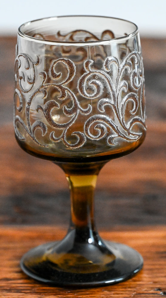 brown scrolls on brown glass Libbey  goblet