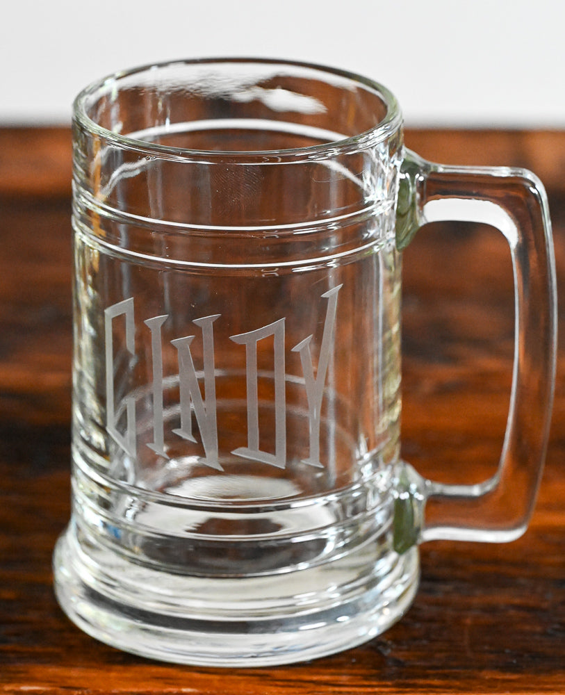 Clear Beer stein etched with "cindy" on wooden table