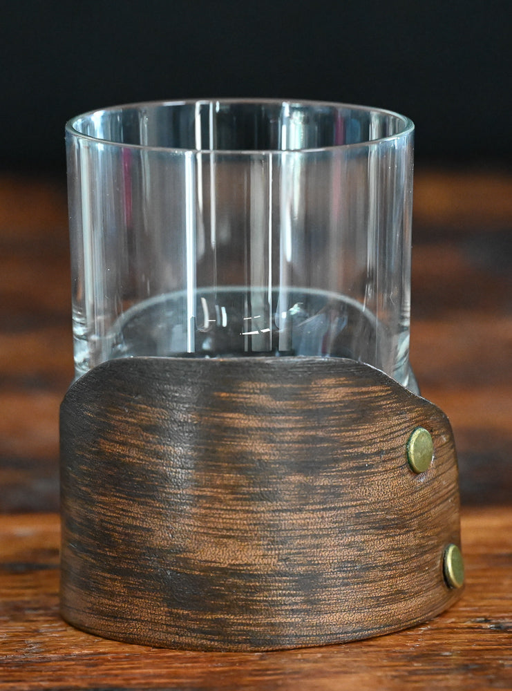clear rocks glass sitting in leather holder 