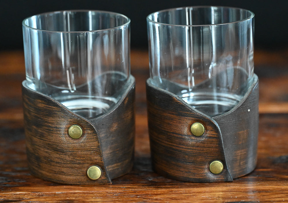 clear rocks glass sitting in leather holder 