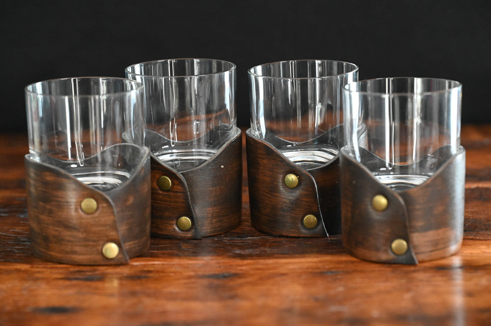 clear rocks glass sitting in leather holder 