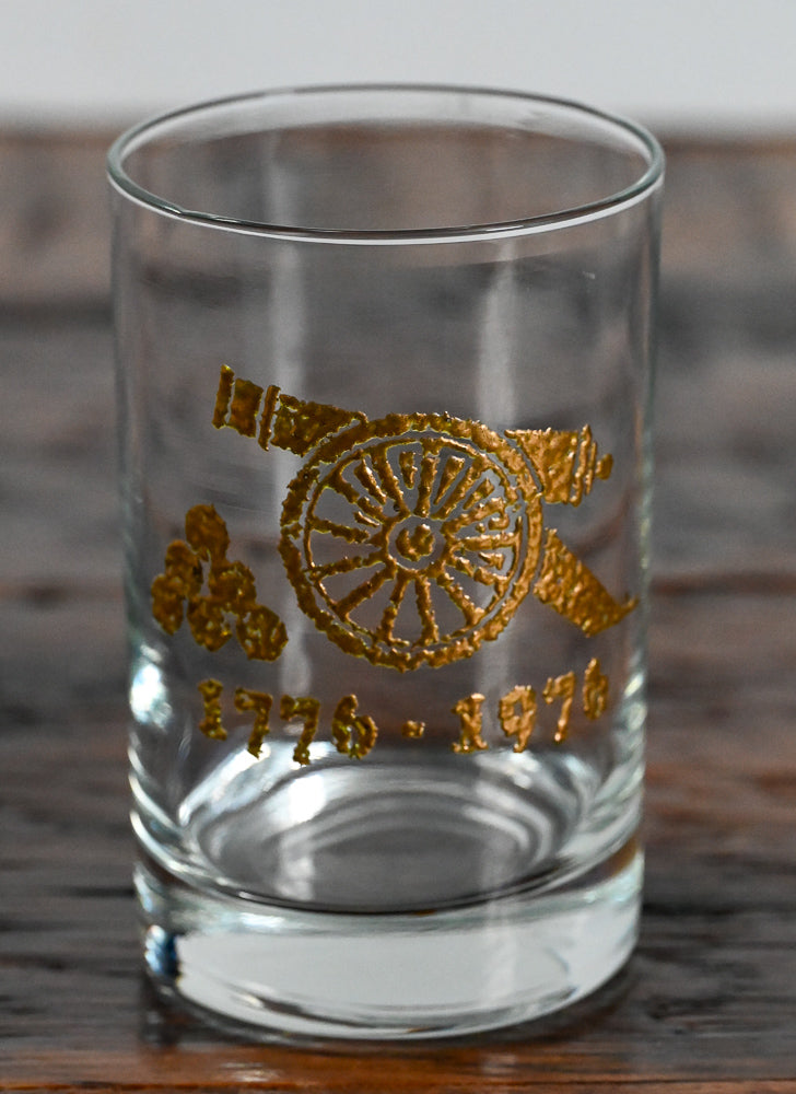 gold cannon and 1776-1976 on clear double rocks glass