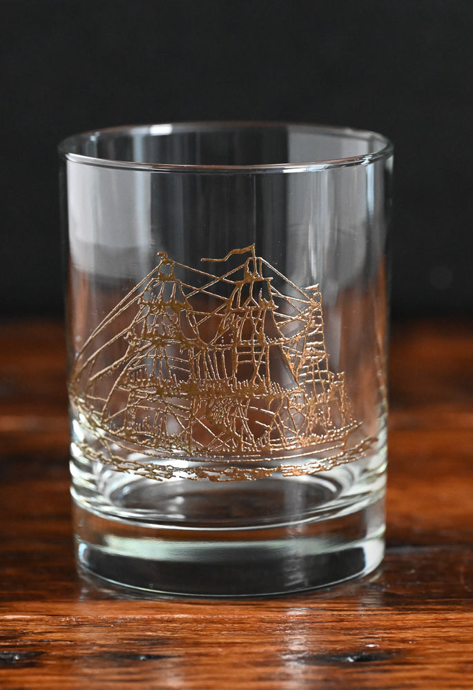 clear rocks glass with gold clipper ship