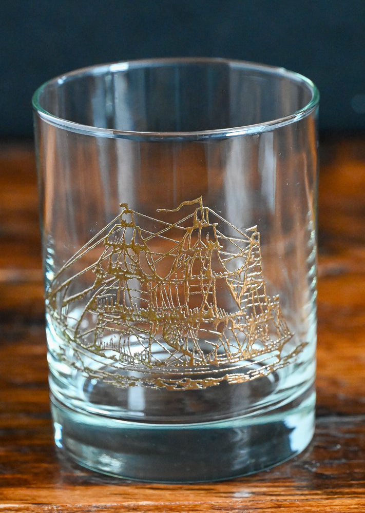 clear rocks glass with gold clipper ship