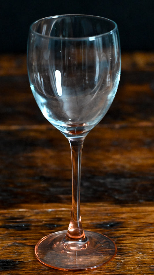 clear wine glass with pink glass stem