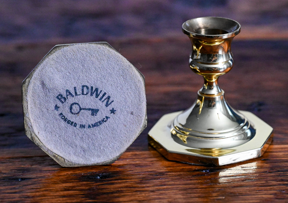 Baldwin brass candlesticks on wood table