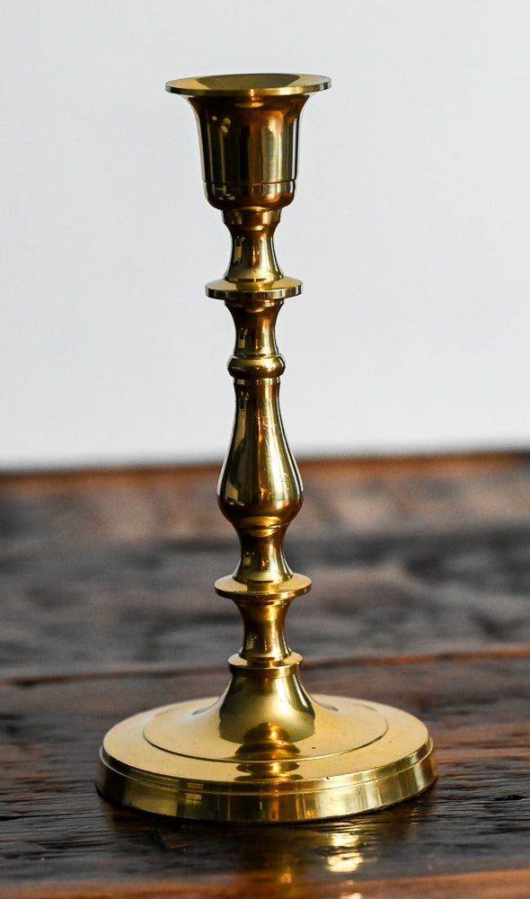brass candlestick on wood table