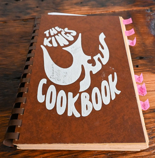 brown cover with white dove of The King's Cookbook